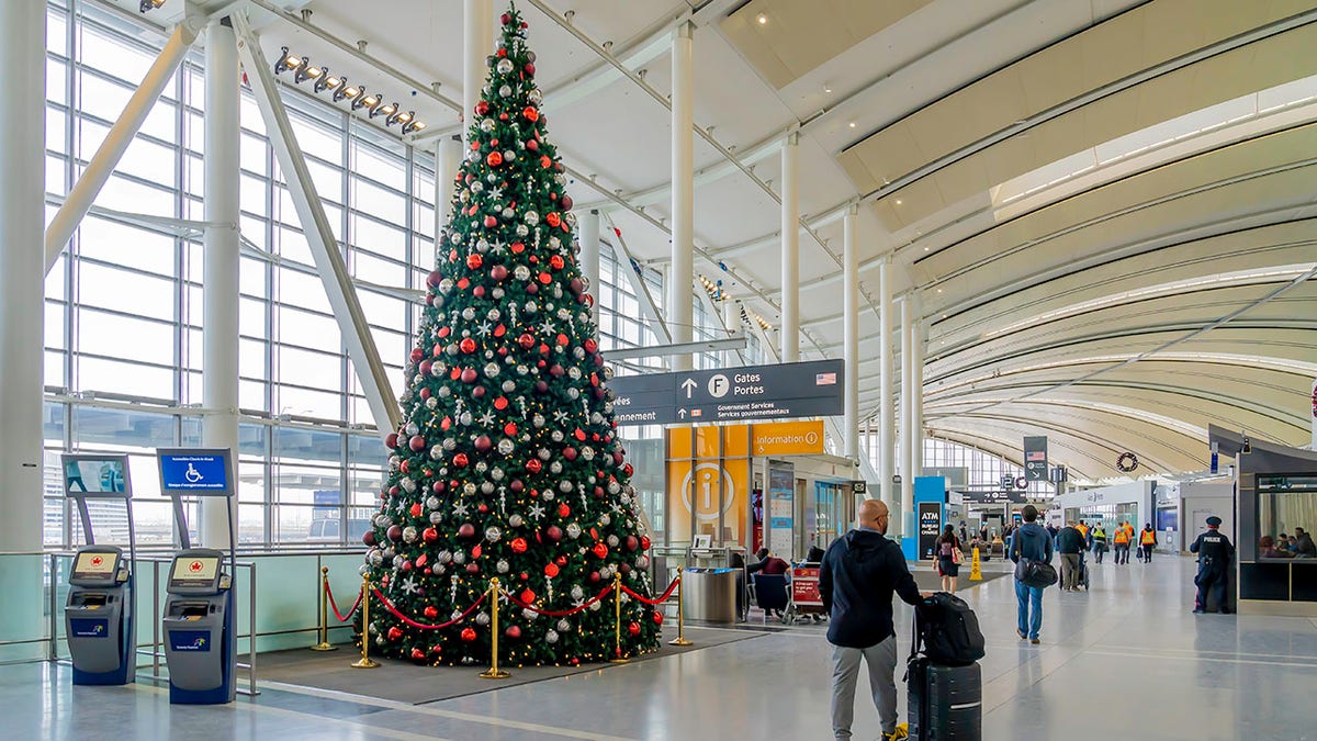 A passenger passed by a Christmas tree at Pearson Airport in Toronto.