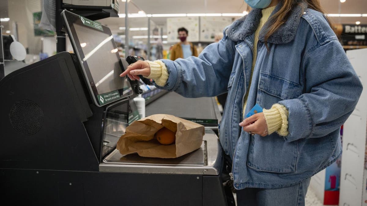 Woman at self-checkout