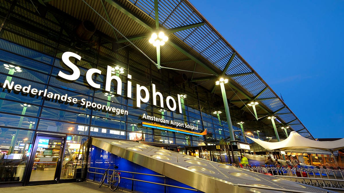 Illuminated entrance of Amsterdam Airport Schiphol at night