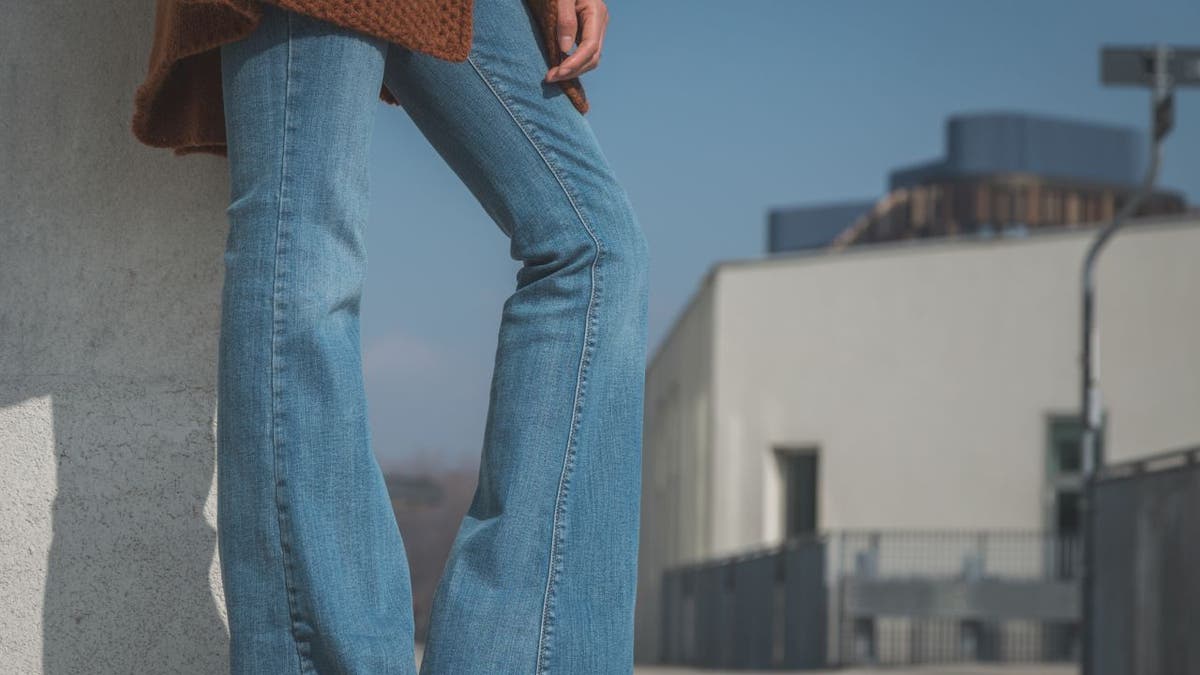Detail photo of a girl wearing flared jeans.