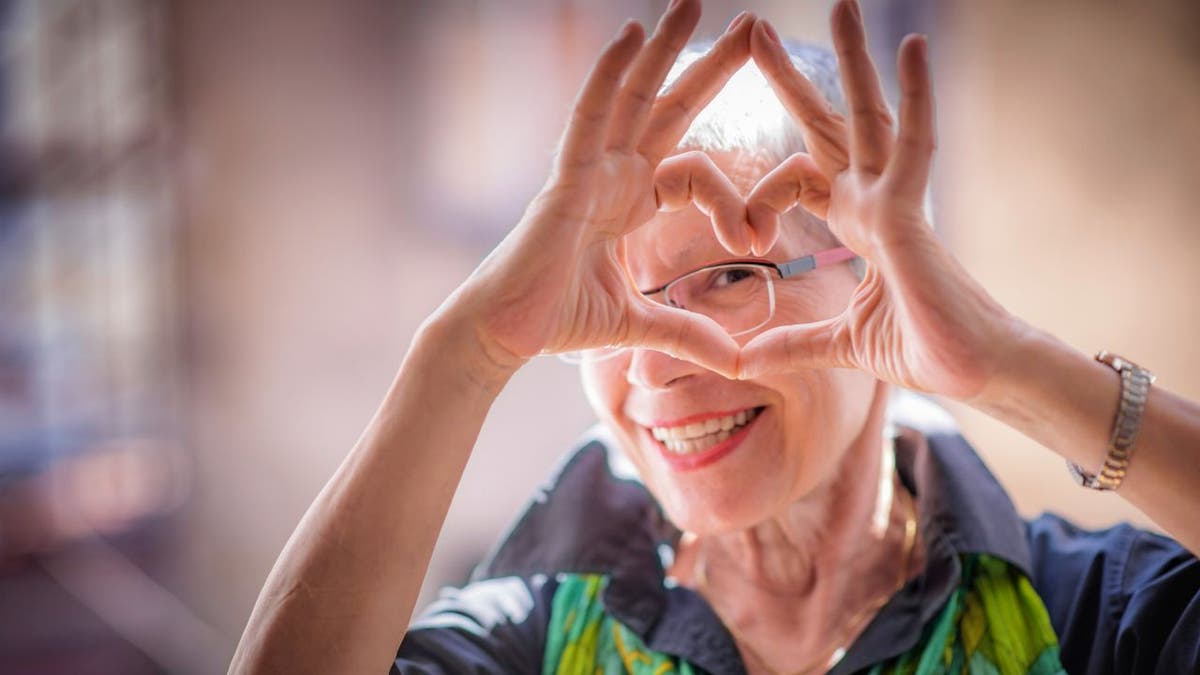 senior woman making heart sign