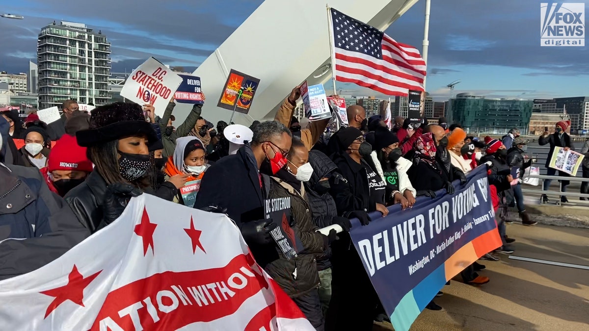 The King family leads hundreds of marchers across the Frederick Douglass Memorial Bridge