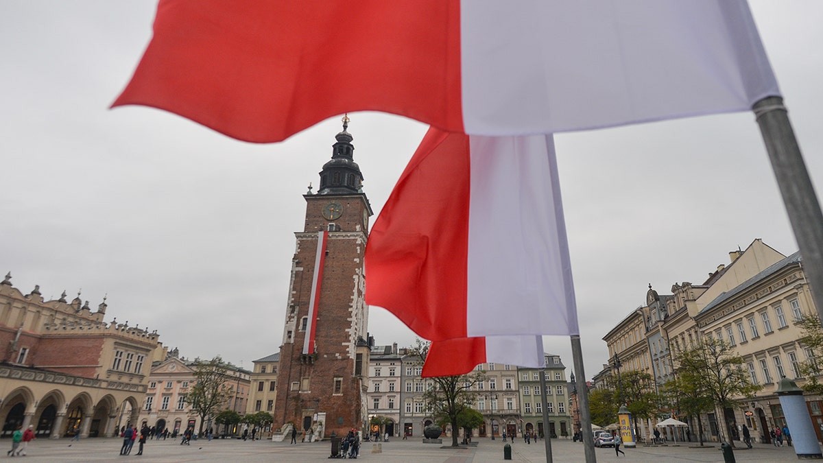 Krakow's UNESCO Market Square decorated with white-red flags on Polish Independence Day 2020.