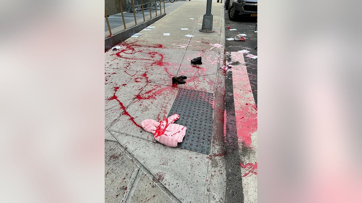 Artist Scott Lolaido poured stage blood on the street outside of Manhattan District Attorney Alvin Bragg's office Tuesday to protest his progressive policies amid a surge in violence. 