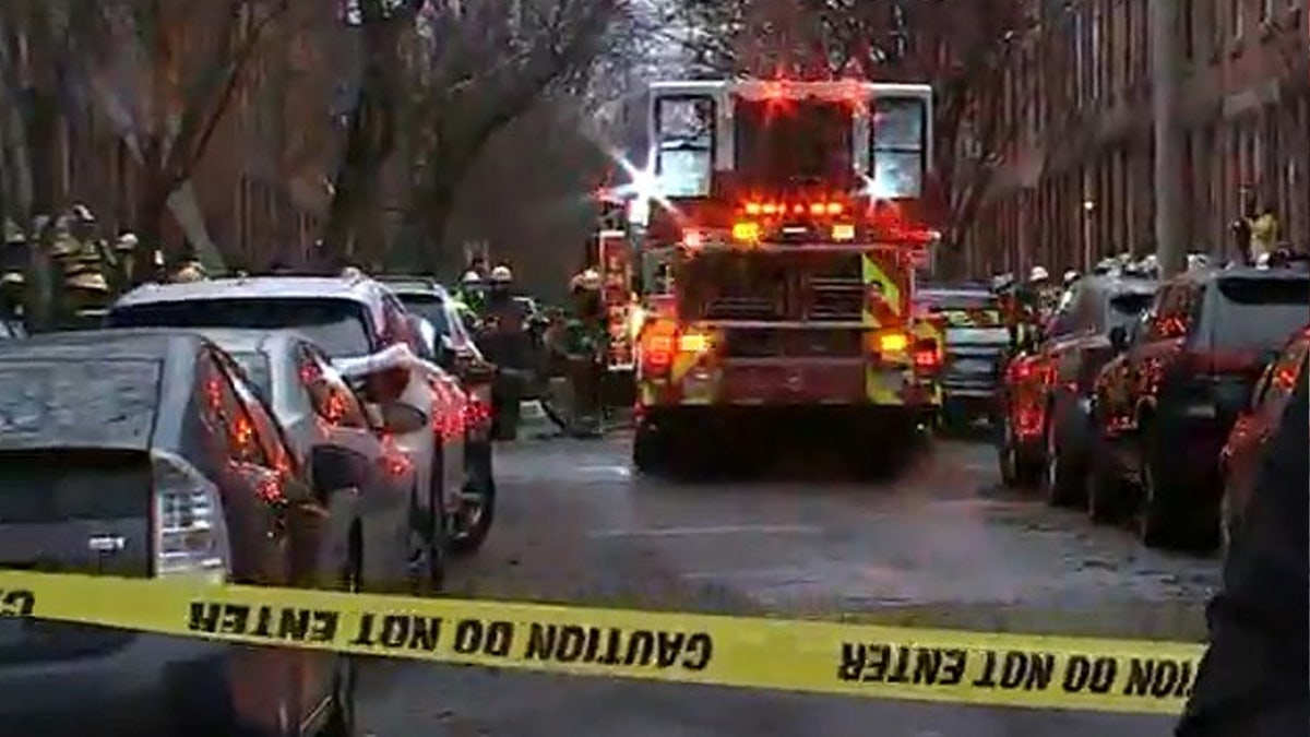 Fire crews arrive at the scene of a fatal fire Wednesday morning in Philadelphia.