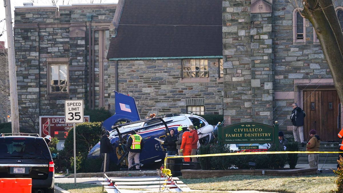 A medical helicopter rests next to the Drexel Hill United Methodist Church after it crashed in the Drexel Hill section of Upper Darby, Pennsylvania, on Wednesday, Jan. 12, 2022.