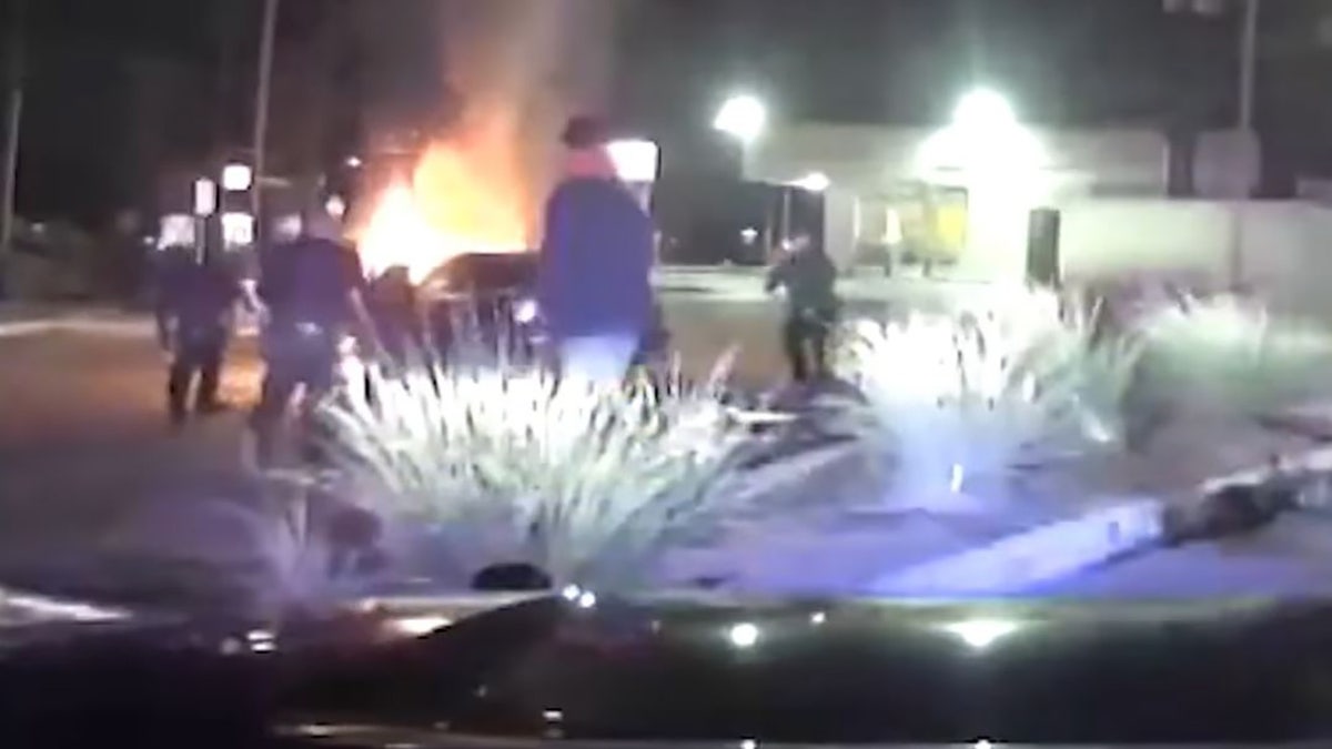 Police in Texas have released body camera footage of an officer racing against the flames that engulfed a car to pull out a woman who was trapped inside.