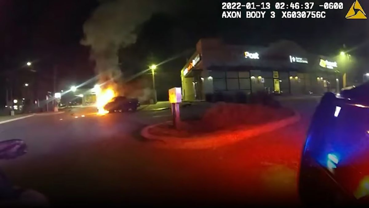 Police in Texas have released body camera footage of an officer racing against the flames that engulfed a car to pull out a woman who was trapped inside.