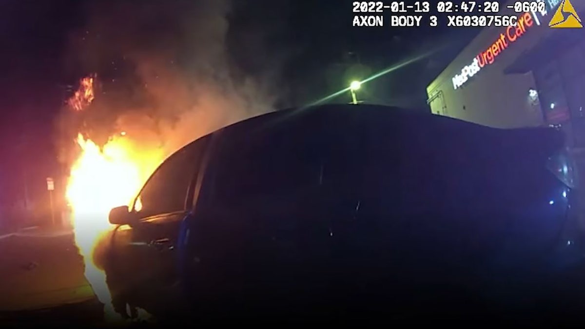 Police in Texas have released body camera footage of an officer racing against the flames that engulfed a car to pull out a woman who was trapped inside.