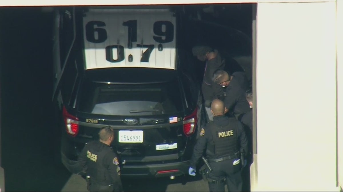 Aerial images obtained by FOX 11 Los Angeles show police putting Shawn Laval Smith into the back of a police SUV ahead of his expected transfer to LAPD custody. 