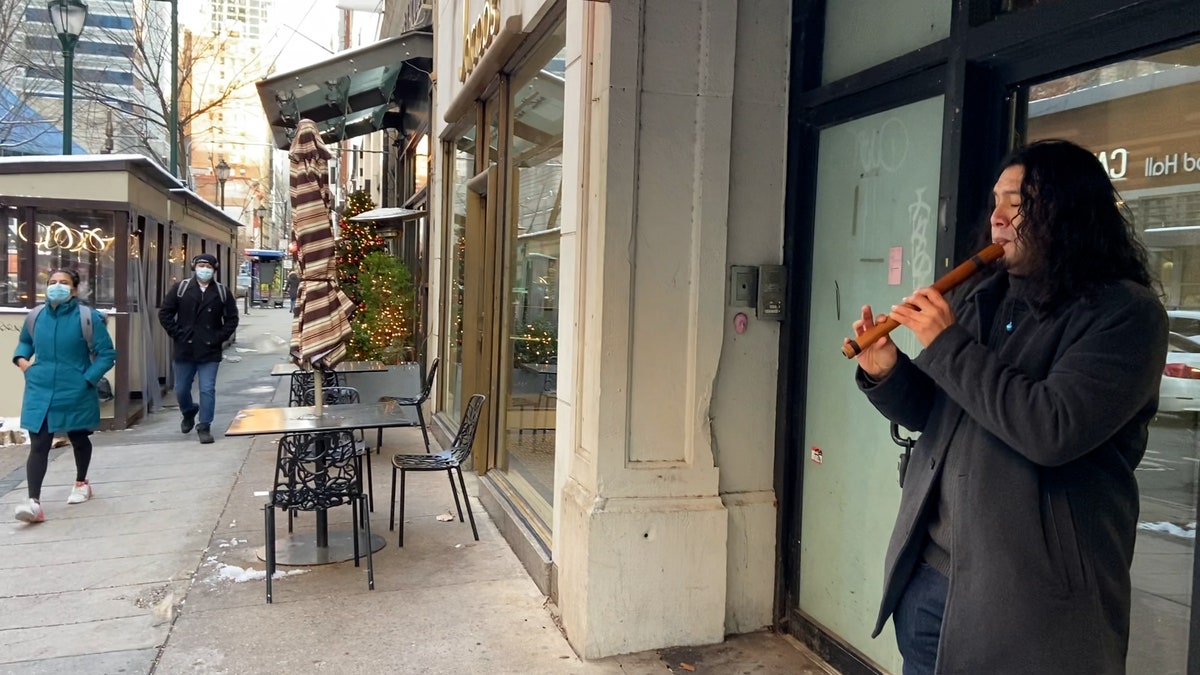 Street performer Stuart Lopez plays the quena in Philadelphia.