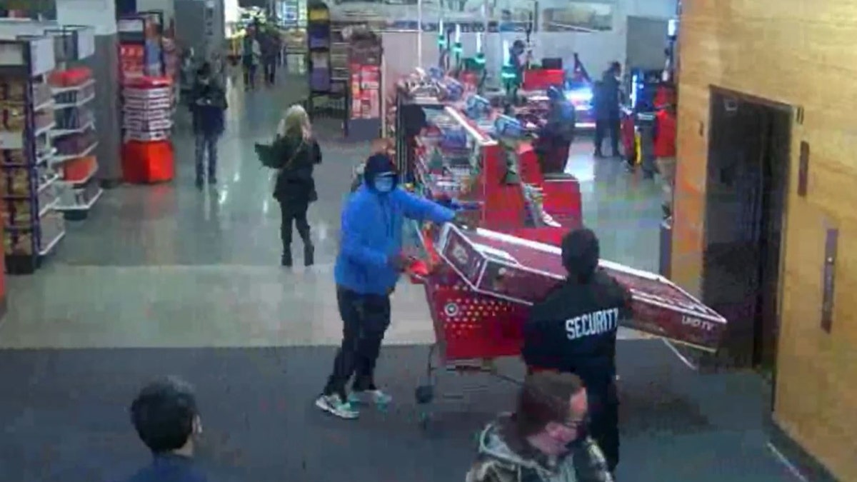 Target surveillance video shows security confronting John Ray Lomack as he allegedly tries to steal a TV from Seattle store