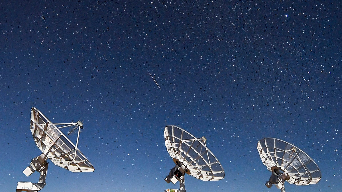 A meteor of Geminid meteor shower streaks over radio telescopes at Daocheng County in the early morning on Dec. 14, 2021, in Garze Tibetan Autonomous Prefecture, Sichuan Province of China. 