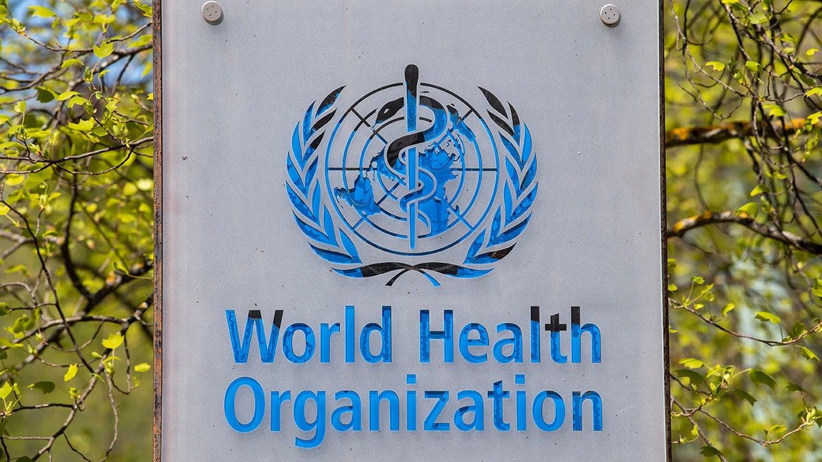 The logo and building of the World Health Organization (WHO) headquarters in Geneva, Switzerlan
