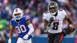 Atlanta Falcons' Kyle Pitts (8) runs away from Buffalo Bills' Dane Jackson (30) during the first half of an NFL football game Sunday, Jan. 2, 2022, in Orchard Park, N.Y.