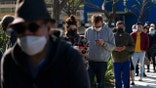 People wait in line for a COVID-19 test in Los Angeles, Tuesday, Jan. 4, 2022. California is starting to feel the full wrath of the omicron variant. Hospitalizations have jumped nearly 50% since Christmas and models show that in a month the state could have 22,000 people in hospitals, which was the peak during last winter’s epic surge. (AP Photo/Jae C. Hong)
