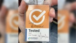 Orange badge that unvaccinated former Brookhaven engineer John Rothermel was told he should wear.