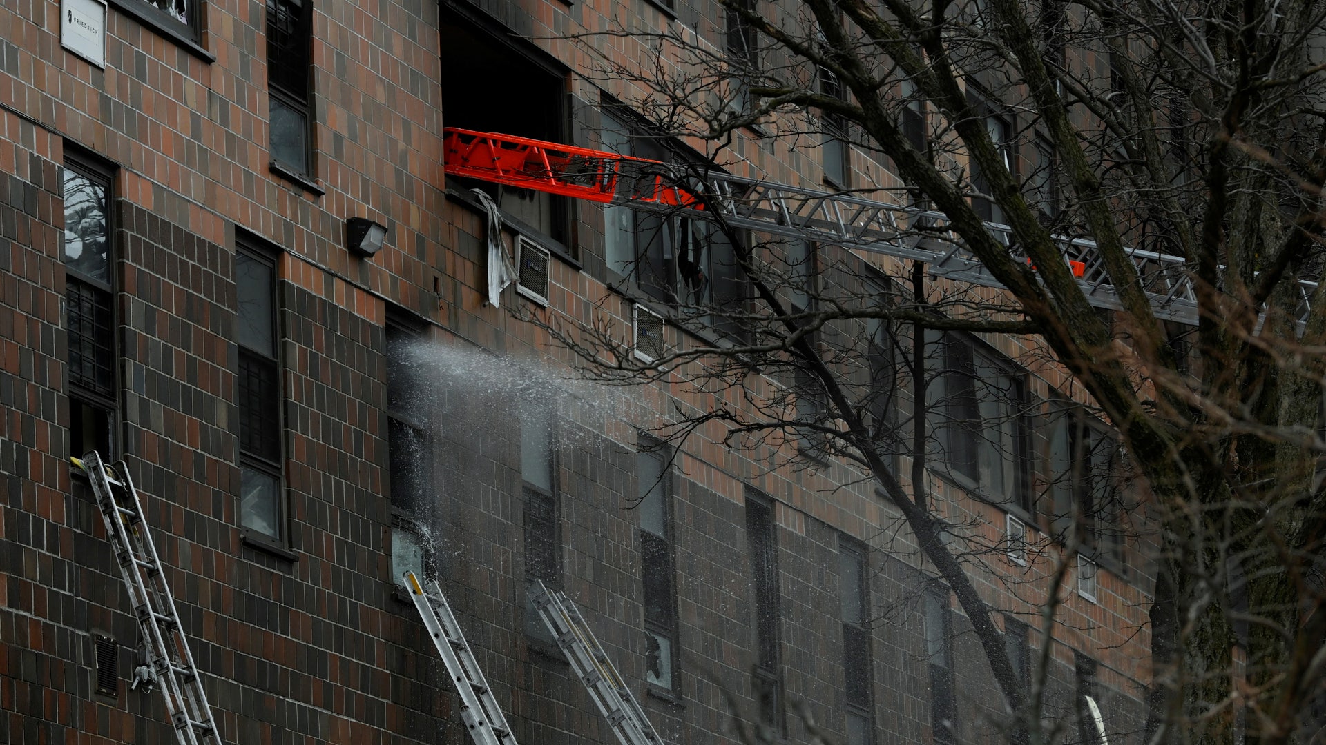 Emergency personnel from the FDNY respond to an apartment building fire in the Bronx