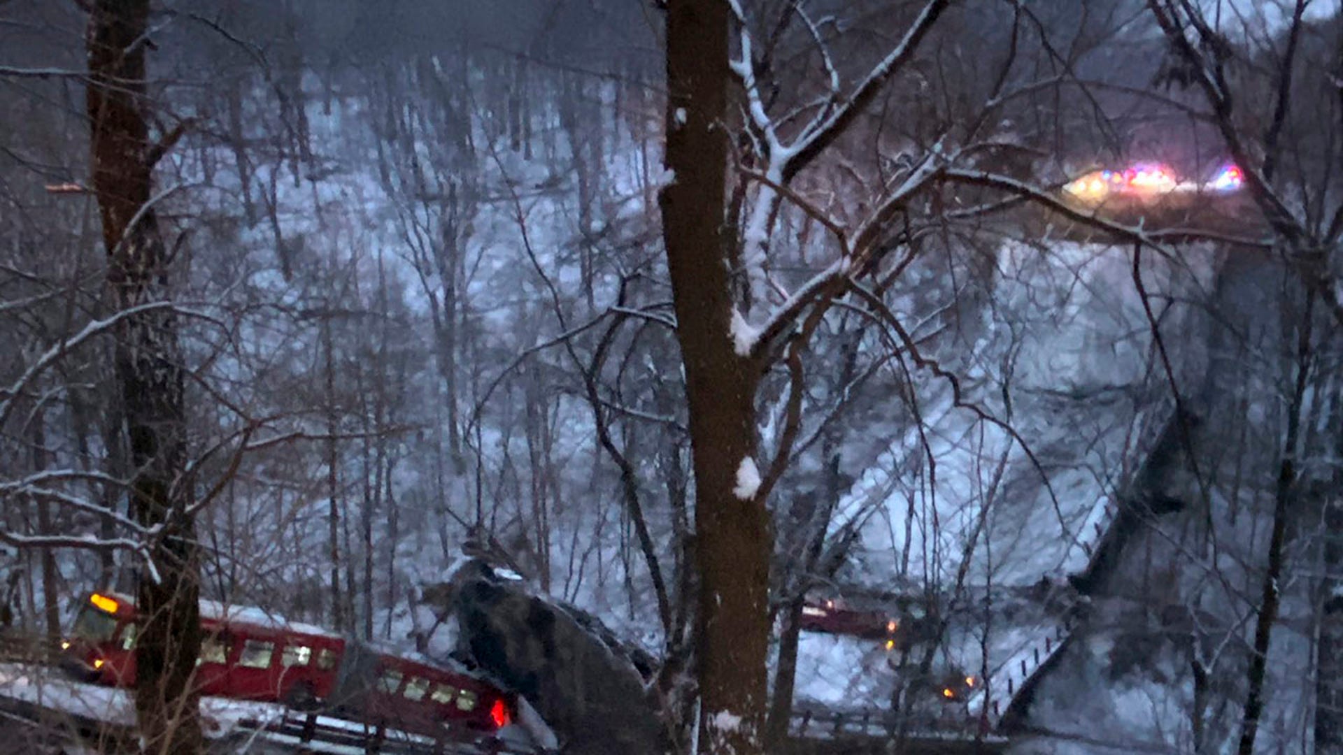 A commuter bus sits upright on a section of a collapsed bridge in Pittsburgh, on Friday, Jan. 28, 2022.  (Greg Barnhisel via AP)