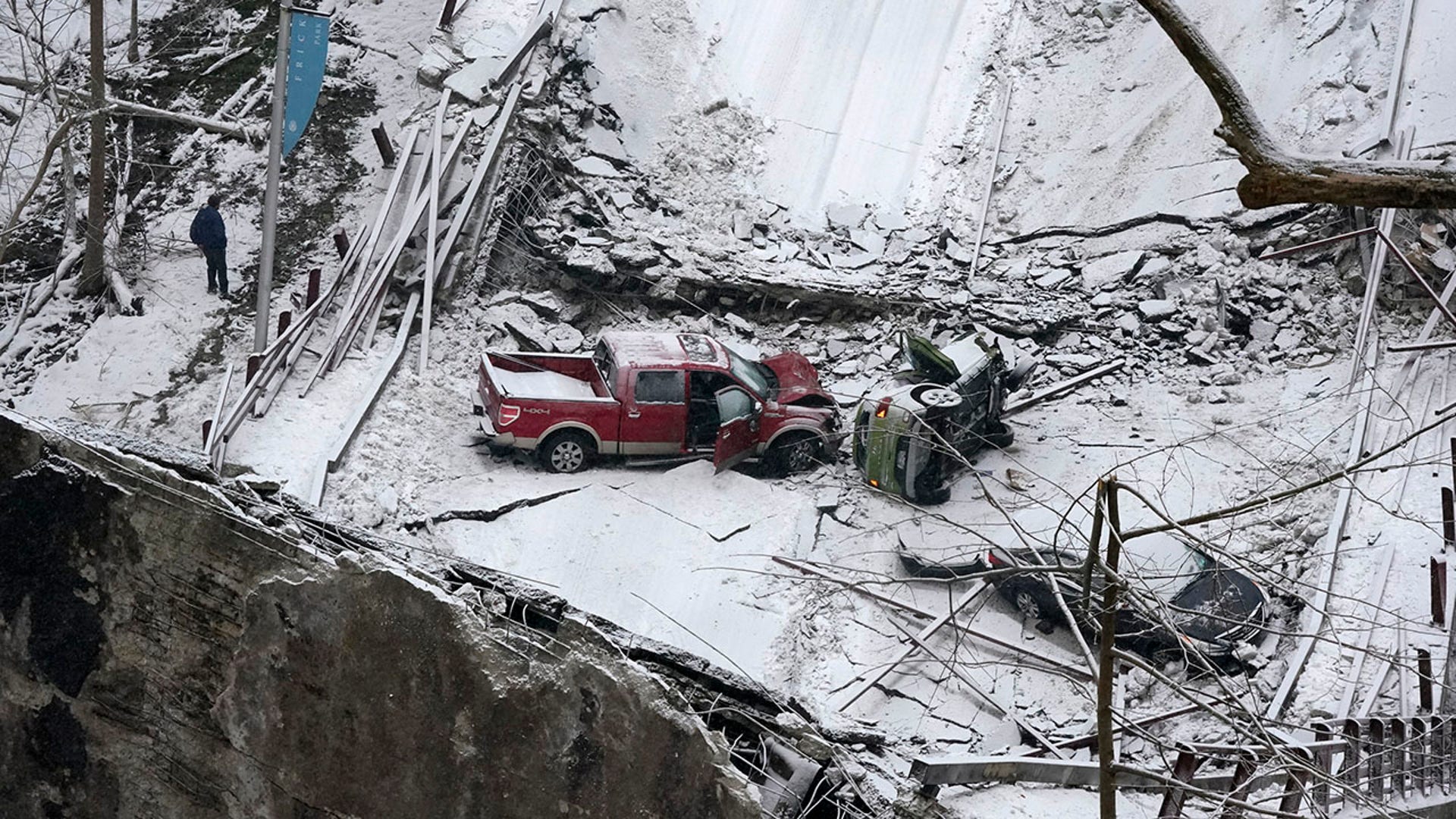 Vehicles that were on a bridge when it collapsed are visible, Friday Jan. 28, 2022, in Pittsburgh's East End. (AP Photo/Gene J. Puskar)