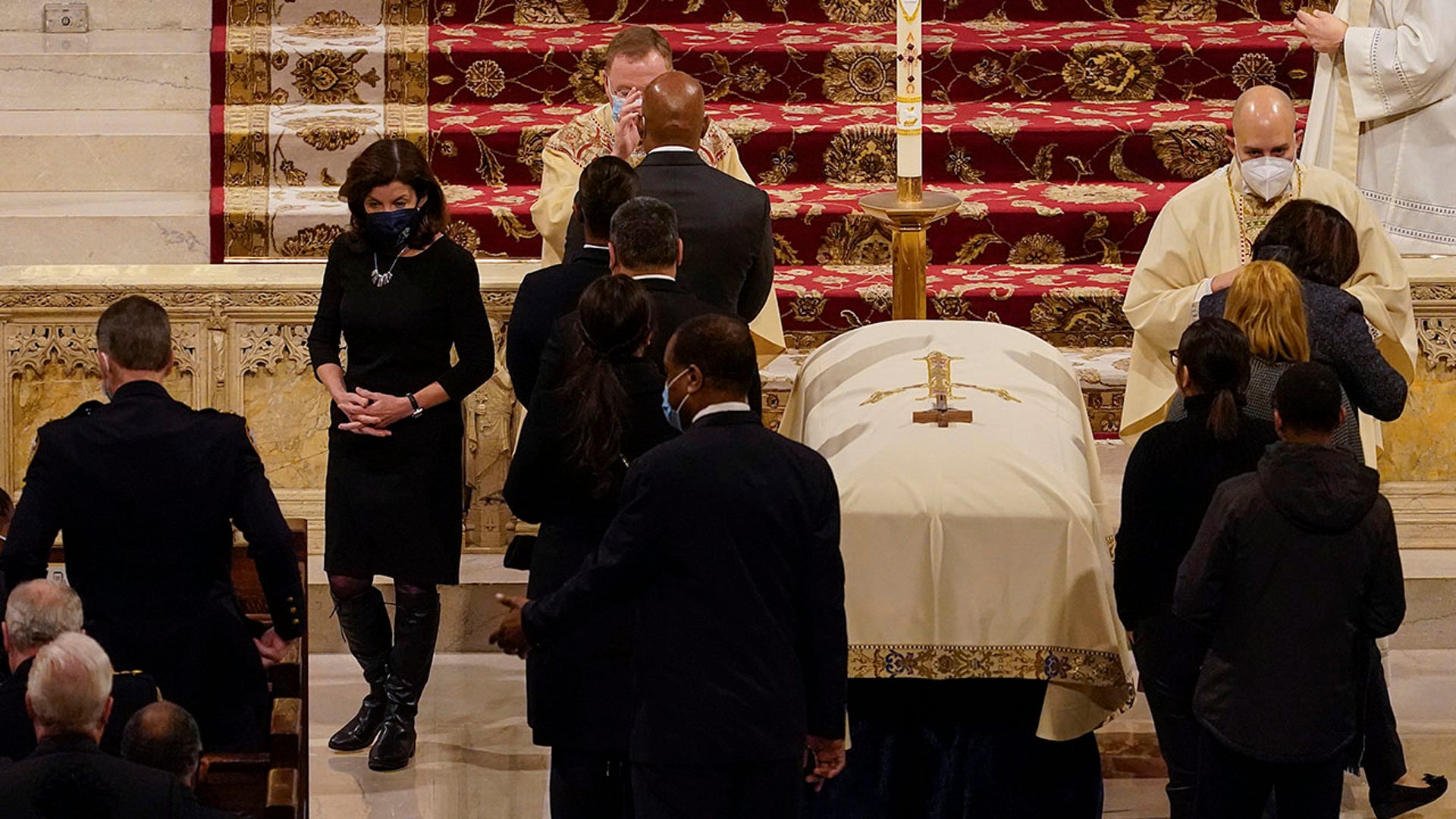 New York Gov. Kathy Hochul, left, walks back to her seat during a funeral service for NYPD officer Jason Rivera Friday, Jan. 28, 2022, at St. Patrick's Cathedral in New York. (AP Photo/Mary Altaffer, POOL)