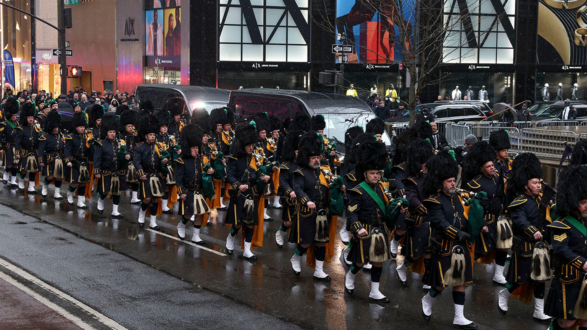The Pipes and Drums Of The Emerald Society of the New York City Police Department march along Fifth Avenue outside St. Patrick's Cathedral during a funeral Service for officer Jason Rivera, Friday, Jan. 28, 2022, in New York.  (AP Photo/Yuki Iwamura)