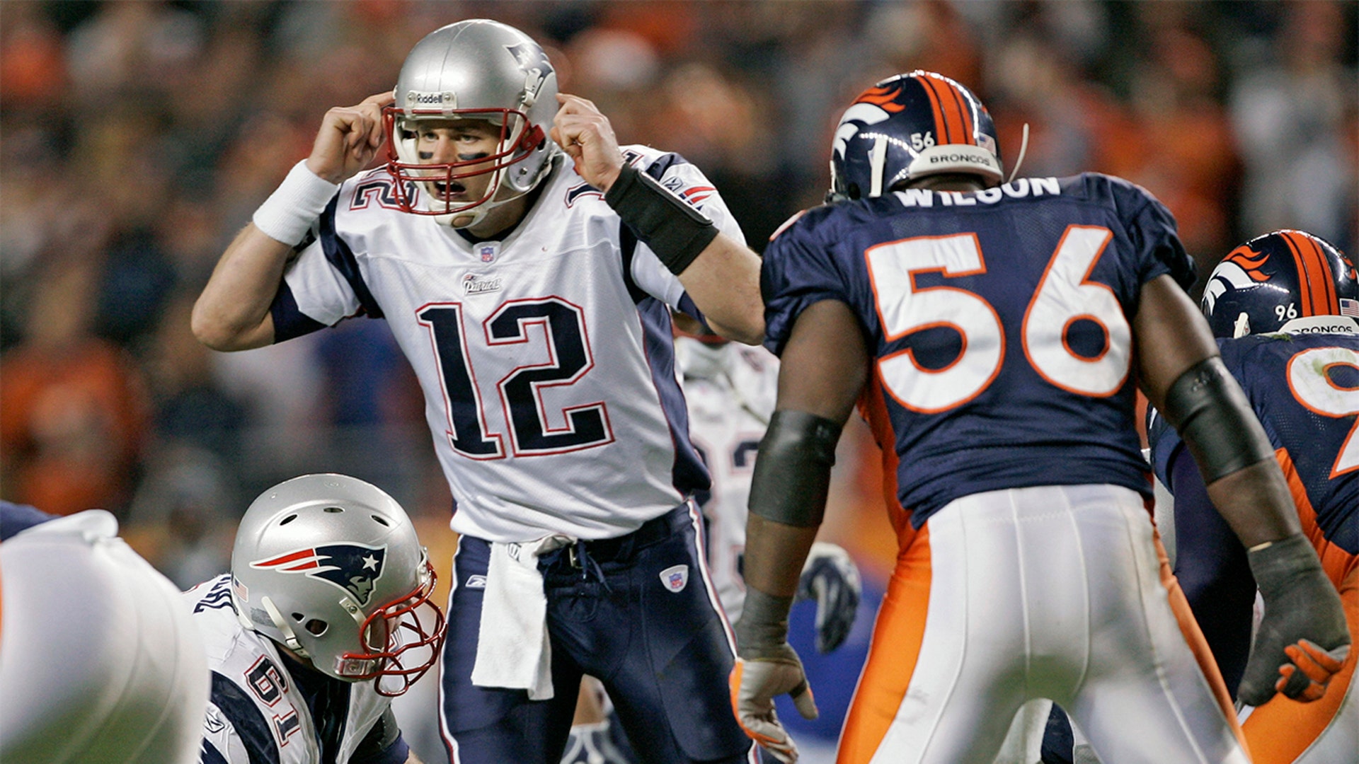 New England Patriots quarterback Tom Brady (12) calls an audible while being watched by Denver Broncos linebacker Al Wilson Saturday, January 14, 2006 at Invesco Field at Mile High in Denver, CO.