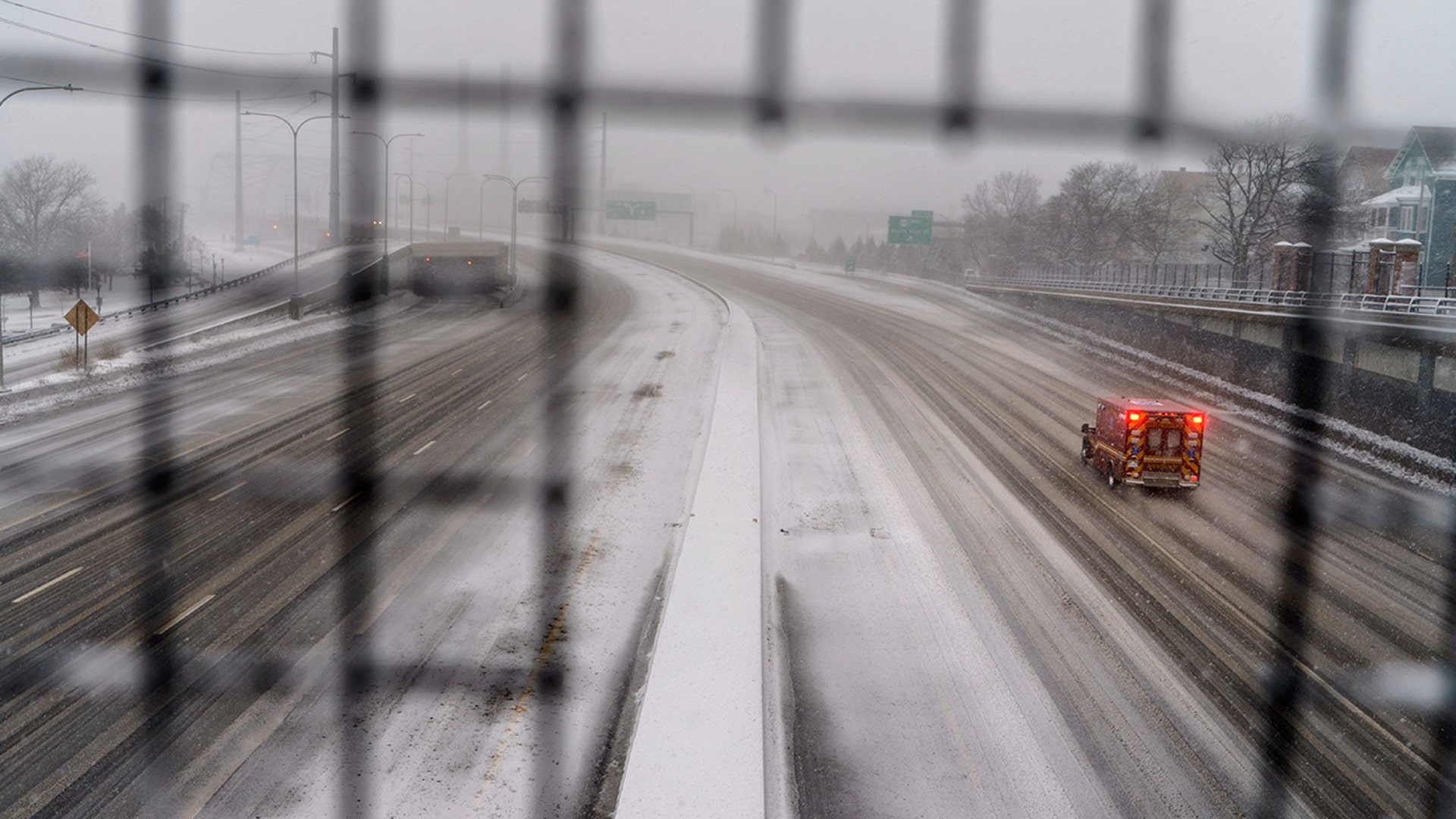 A pedestrian walks through a gust of wind along the waterfront in India Point Park in Providence, R.I., Saturday, Jan. 29, 2022.