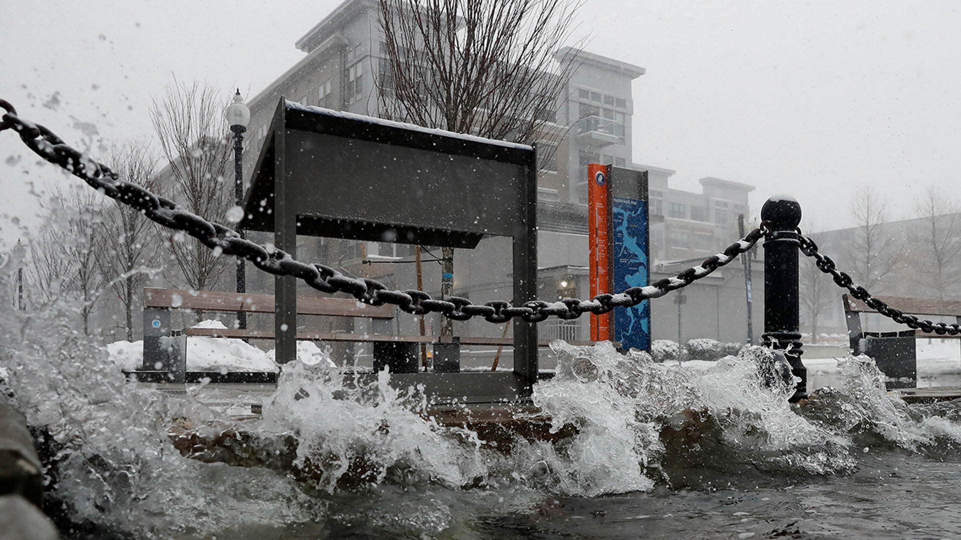 A pedestrian walks through a gust of wind along the waterfront in India Point Park in Providence, R.I., Saturday, Jan. 29, 2022.