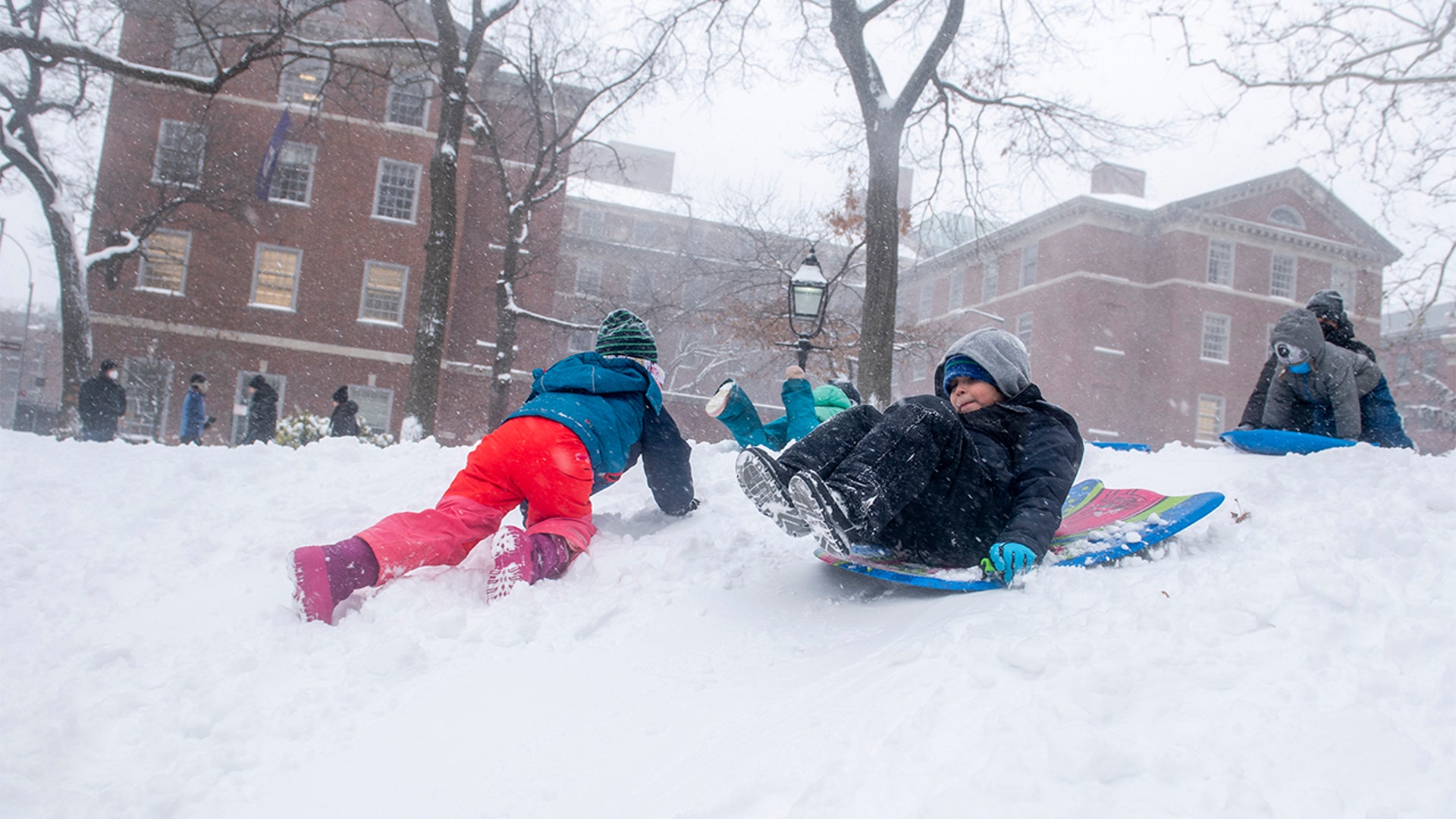 Kids play in the snow during a snow storm in Washington Sq. Park on Saturday, Jan. 29, 2022, in New York.