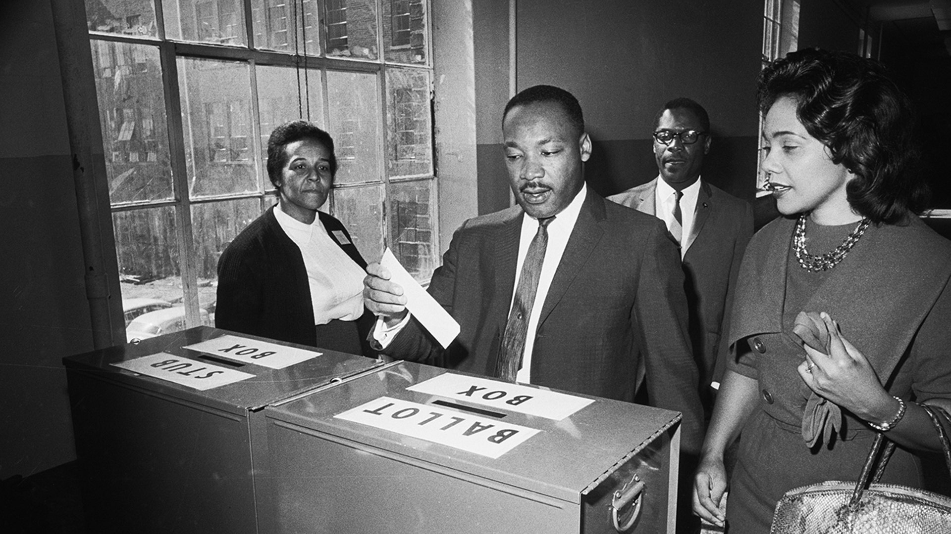 Dr. Martin Luther King Jr. votes as his wife, Coretta Scott King, waits her turn on Nov. 3, 1964 in Atlanta.