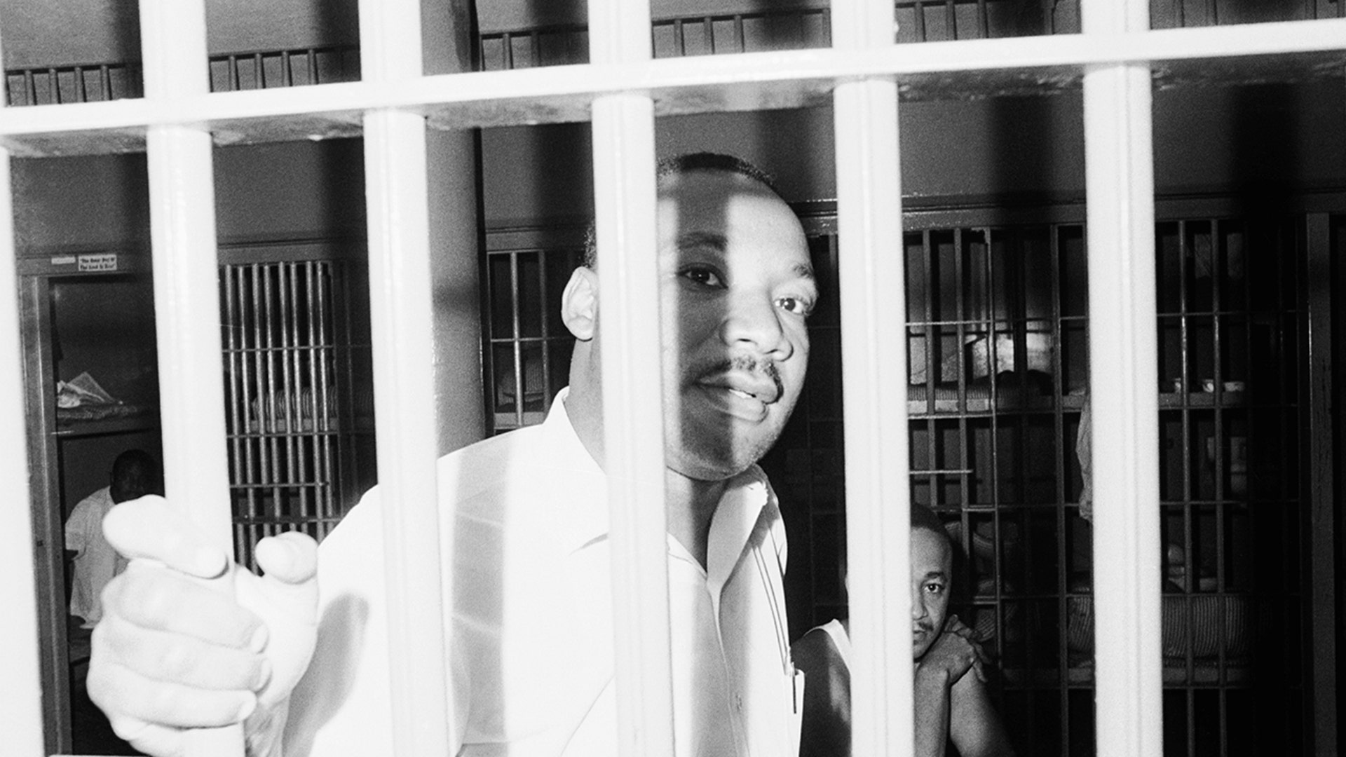 Dr. Martin Luther King peers between the bars of his jail cell at the St. John's County Jail on June 11, 1962, in St. Augustine, Florida, shortly after he and other integration demonstrators were arrested on trespass charges at a local motel.