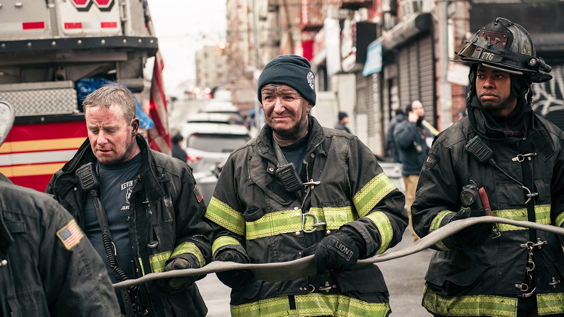 Firefighters work outside an apartment building after a fire in the Bronx