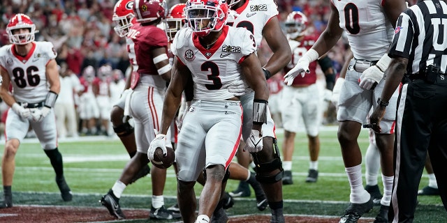 Georgia's Zamir White celebrates after running for a touchdown during the second half of the College Football Playoff championship football game against Alabama Monday, Jan. 10, 2022, in Indianapolis. (AP Photo/Paul Sancya)