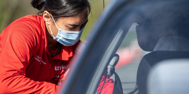 A medical professional from UofL Health administers a vaccine to a patient in their vehicle at University of Louisville Cardinal Stadium on April 12, 2021 in Louisville, Kentucky.  (Photo by Jon Cherry/Getty Images)