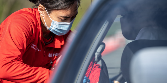 A medical professional from UofL Health administers a vaccine to a patient in their vehicle at University of Louisville Cardinal Stadium on April 12, 2021 in Louisville, Kentucky.  (Photo by Jon Cherry/Getty Images)