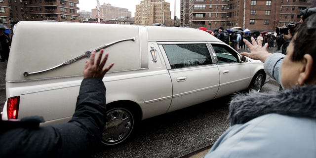 Women wave at the hearse carrying the casket of Nixzmary Brown as it leaves her funeral outside St. Mary's Church in New York January 18, 2006. The seven- year-old Brown was found dead in her Brooklyn home on January 11. The child's mother and step-father are being held in custody on charges of second-degree murder.  REUTERS/Shannon Stapleton