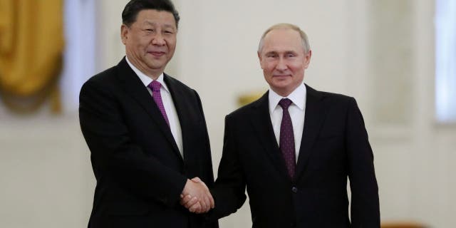 Russian President Vladimir Putin shakes hands with his Chinese counterpart Xi Jinping at the Kremlin in Moscow, Russia