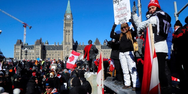 Protestors stand in front of the Parliament Buildings as truckers take part in a convoy to protest coronavirus disease (COVID-19) vaccine mandates for cross-border truck drivers in Ottawa, Ontario, Canada, January 29, 2022.