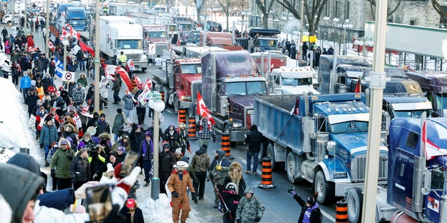 Trucks sit parked on Wellington Street near the Parliament Buildings as truckers and their supporters take part in a convoy to protest COVID-19 vaccine mandates for cross-border truck drivers in Ottawa, Ontario, Canada, Jan. 29, 2022.