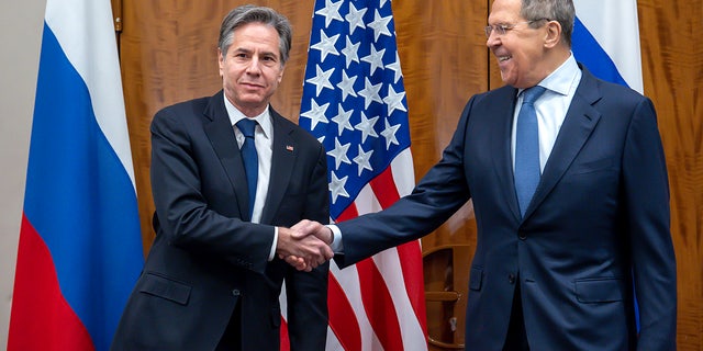 U.S. Secretary of State Antony Blinken, left, shake hands with Russian Foreign Minister Sergei Lavrov, right, prior to their meeting in Geneva, Switzerland. (Martial Trezzini/Keystone via AP)