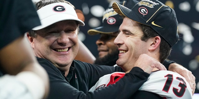 Georgia head coach Kirby Smart celebrates with Stetson Bennett after the College Football Playoff championship football game against Alabama Tuesday, Jan. 11, 2022, in Indianapolis. Georgia won 33-18.