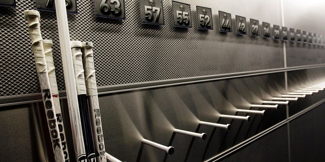 A nearly empty hockey stick rack in the locker room of the Buffalo Sabres hockey team is shown during the NHL labor lockout in Buffalo, New York, Sept. 25, 2012. (Associated Press)
