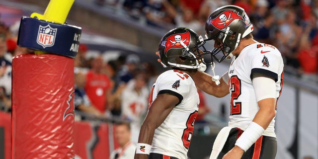 Antonio Brown (81) and Tom Brady (12) of the Tampa Bay Buccaneers celebrate a touchdown during a game against the Dallas Cowboys at Raymond James Stadium Sept. 9, 2021, in Tampa, Fla. 
