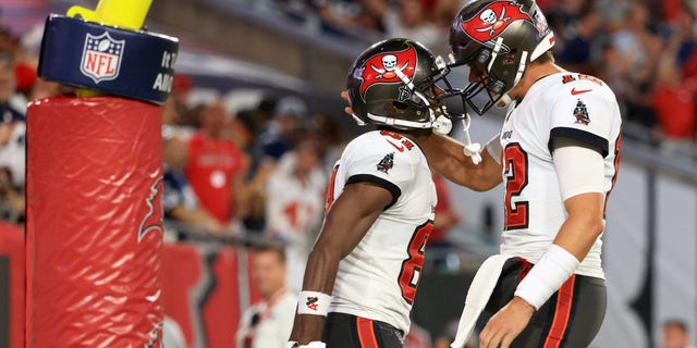 Antonio Brown #81 and Tom Brady #12 of the Tampa Bay Buccaneers celebrate their touchdown  during the second quarter against the Dallas Cowboys at Raymond James Stadium on September 09, 2021 in Tampa, Florida. 