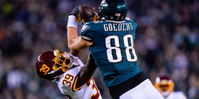 Philadelphia Eagles' Dallas Goedert, right, makes a catch while Washington Football Team's Jeremy Reaves defends during the first half of an NFL football game, Tuesday, Dec. 21, 2021, in Philadelphia.
