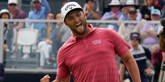 FILE - Jon Rahm, of Spain, reacts to making his birdie putt on the 18th green during the final round of the U.S. Open Golf Championship, June 20, 2021, at Torrey Pines Golf Course in San Diego. Rahm says he usually pumps his fist downward. This was upward toward his family across the green in a corporate box.