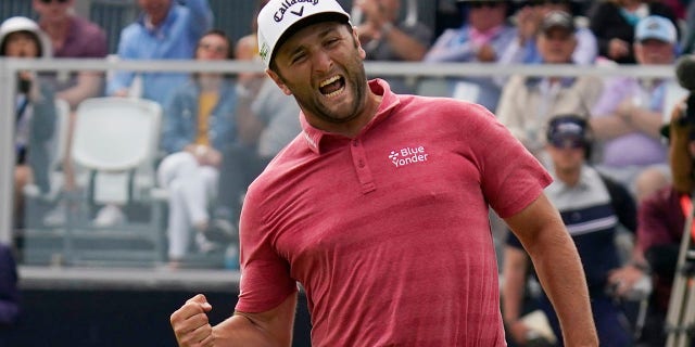 LÊER - Jon Rahm, of Spain, reacts to making his birdie putt on the 18th green during the final round of the U.S. Open Golf Championship, Junie 20, 2021, at Torrey Pines Golf Course in San Diego. Rahm says he usually pumps his fist downward. This was upward toward his family across the green in a corporate box.