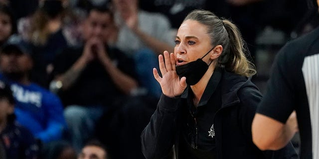 FILE - San Antonio Spurs assistant coach Becky Hammon during the first half of an NBA basketball game against the Dallas Mavericks, Friday, Nov. 12, 2021, in San Antonio.  Hammon is finalizing a deal to become the next coach of the Las Vegas Aces. A person familiar with the situation confirmed the move to The Associated Press on condition of anonymity because no official announcement has been made. She’s expected to be the highest paid coach in the WNBA, earning way more than the highest paid player in the league.