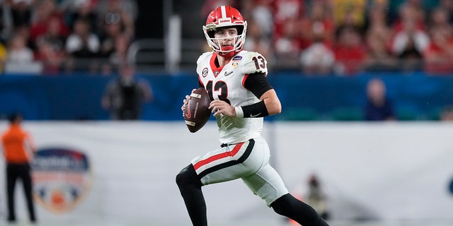 Georgia quarterback Stetson Bennett looks to pass out of the pocket against Michigan during the second half of the Orange Bowl NCAA College Football Playoff semifinal game, Friday, Dec. 31, 2021, in Miami Gardens, Florida.